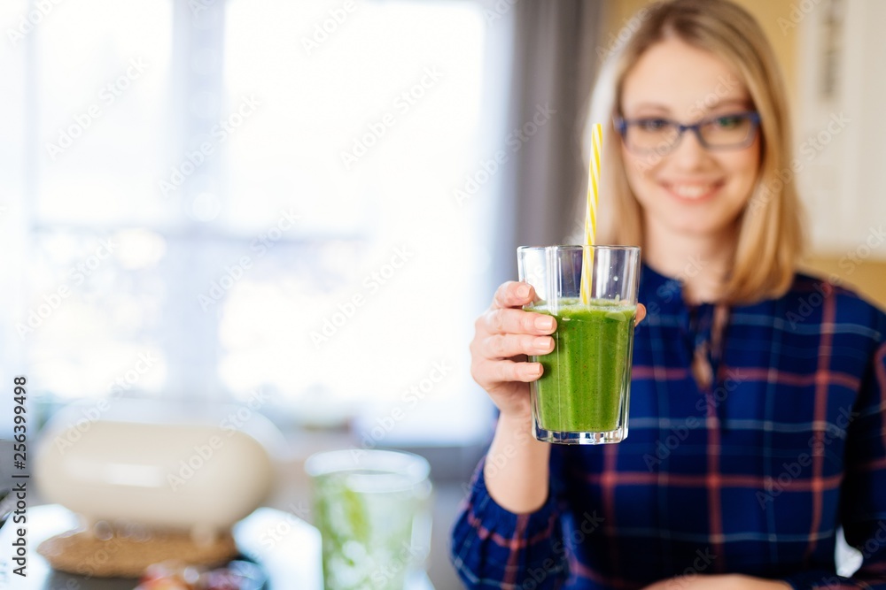 Woman giving smoothie in glass cup. Woman giving smoothie in glass cup.