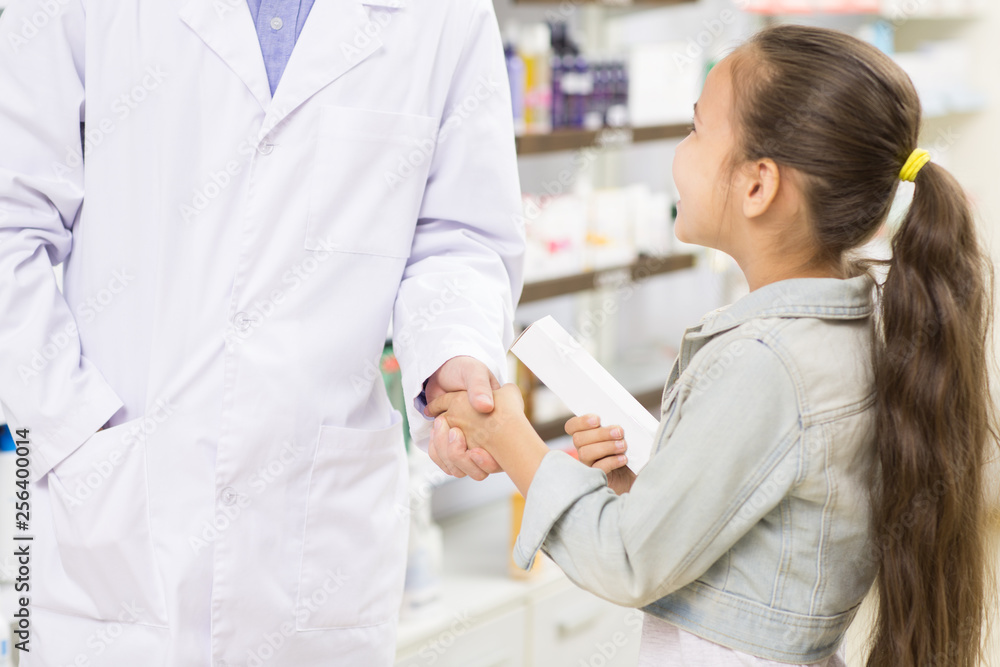 Pharmacist helping little girl at the drugstore Pharmacist helping little girl at the drugstore