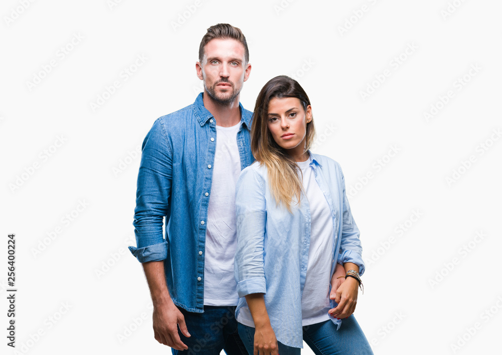 Young couple in love over isolated background with serious expression on face. Simple and natural looking at the camera. Young couple in love over isolated background with serious expression on face. Simple and natural looking at the camera.