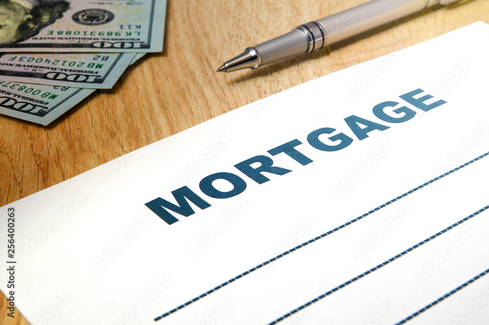 Fototapeta premium Mortgage with a pen, money on the table.