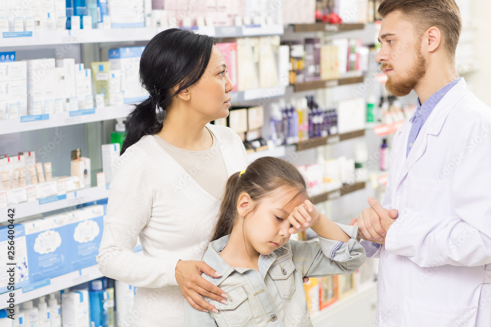 Professional pharmacist helping his customers