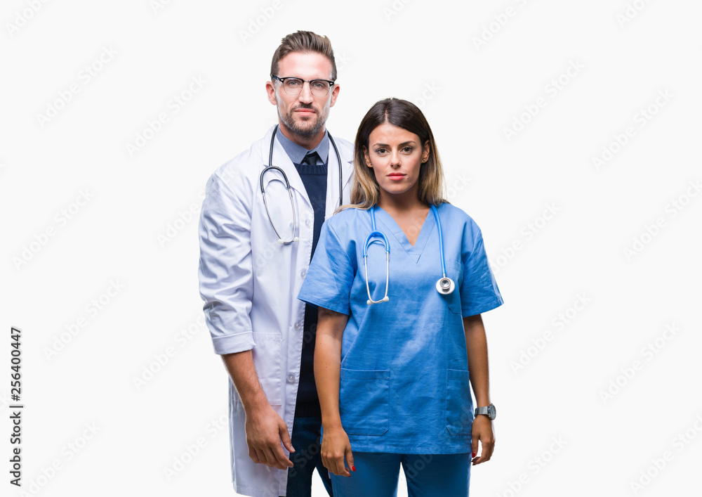 Young couple of doctor and surgeon over isolated background with serious expression on face. Simple and natural looking at the camera. Young couple of doctor and surgeon over isolated background with serious expression on face. Simple and natural looking at the camera.