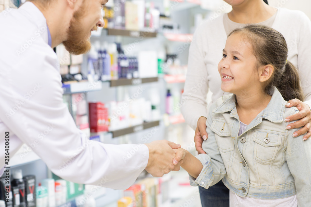 Professional pharmacist helping his customers Professional pharmacist helping his customers