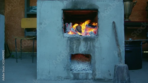 Burning fire in old-fashioned traditional Ukrainian stove. photo