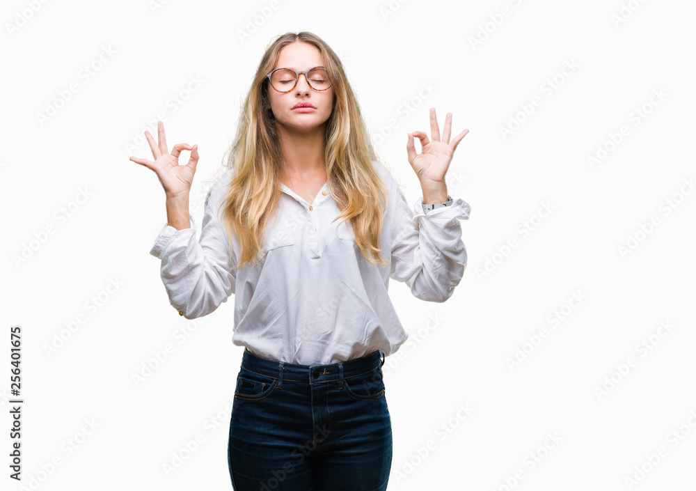 Young beautiful blonde business woman wearing glasses over isolated background relax and smiling with eyes closed doing meditation gesture with fingers. Yoga concept.