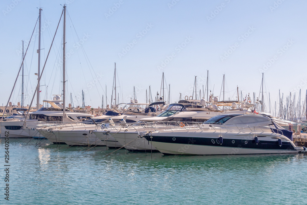 Alicante, Spain, March 17, 2019: Tight marine yacht parking in calm water on bright sunny day