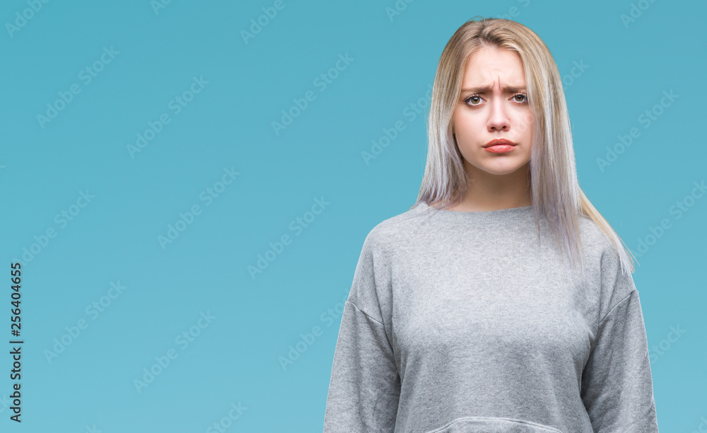 Young blonde woman over isolated background skeptic and nervous, frowning upset because of problem. Negative person. Young blonde woman over isolated background skeptic and nervous, frowning upset because of problem. Negative person.