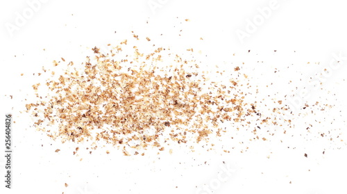 Ground, milled nutmeg powder isolated on white background, top view