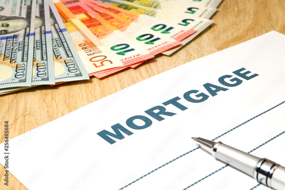 Mortgage with a pen, money on the table. Mortgage with a pen, money on the table.