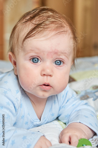 Portret of a baby in blue toddlers with blue eyes