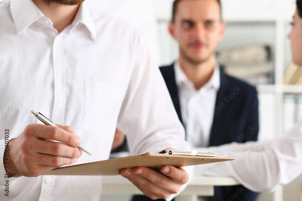 Male arm in suit hold silver pen Male arm in suit hold silver pen