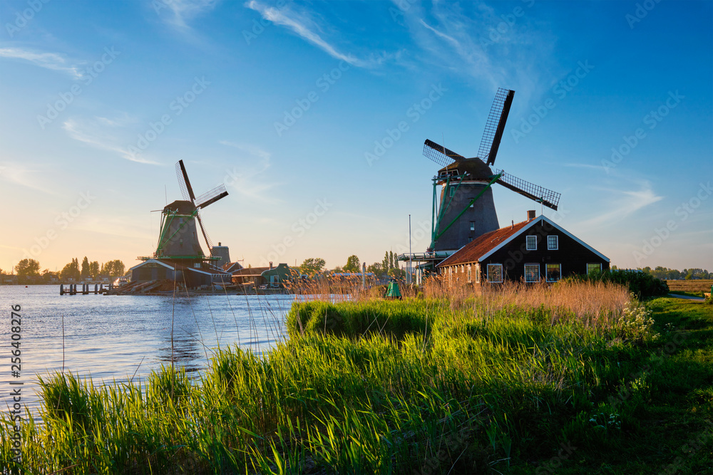 Naklejka premium Windmills at Zaanse Schans in Holland on sunset. Zaandam, Netherlands