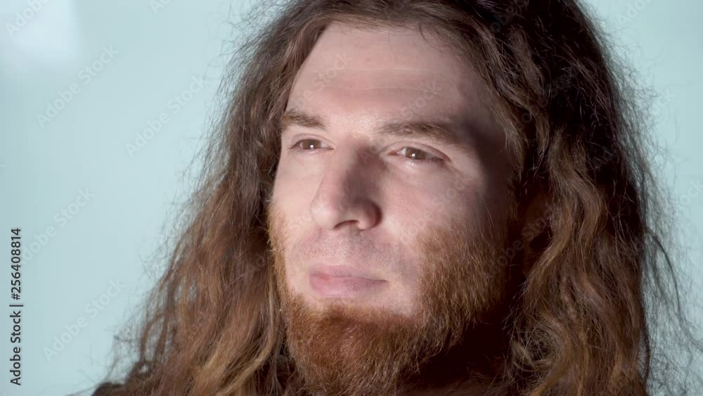 Man smiling in glamour shot on whitish background long hair beard solo Man smiling in glamour shot on whitish background long hair beard solo