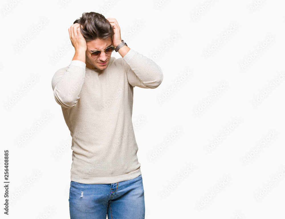 Young handsome man wearing sunglasses over isolated background suffering from headache desperate and stressed because pain and migraine. Hands on head. Young handsome man wearing sunglasses over isolated background suffering from headache desperate and stressed because pain and migraine. Hands on head.