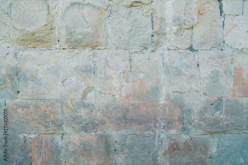 Texture of old masonry walls in Georgia. Sunlight and shadows from the leaves on the bricks.