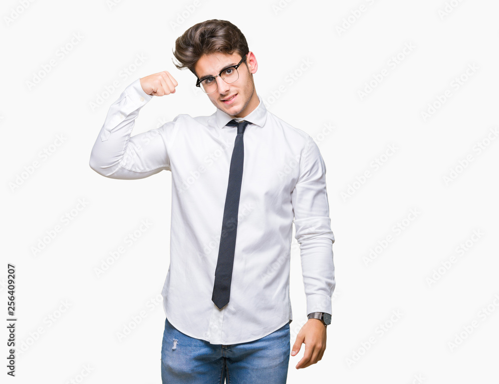 Young business man wearing glasses over isolated background Strong person showing arm muscle, confident and proud of power Young business man wearing glasses over isolated background Strong person showing arm muscle, confident and proud of power