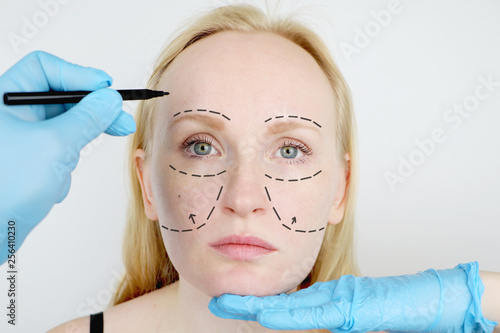 Facial plastic surgery or facelift  facelift  face correction. A plastic surgeon examines a patient before plastic surgery.