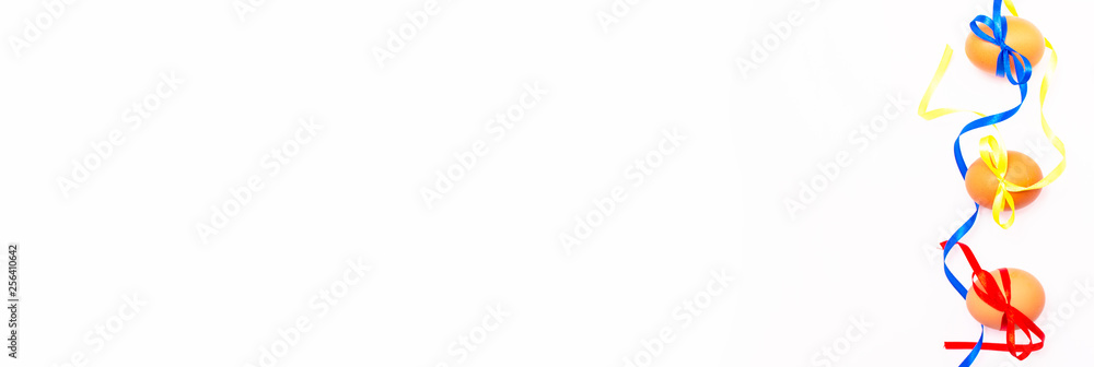 Easter eggs, multicolored, on white background with ribbons Easter eggs, multicolored, on white background with ribbons