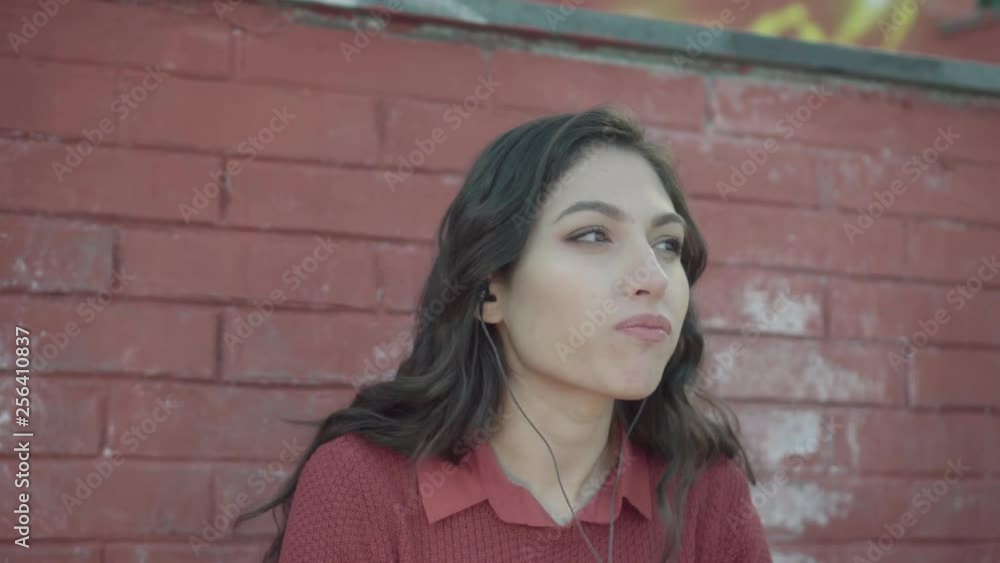 Girl speaking She tells a story with brick wall in the background Girl speaking She tells a story with brick wall in the background