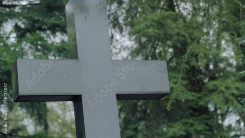 Cross and Tombstone in Green Graveyard