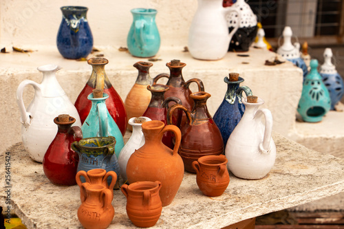 Ceramic jugs and lanterns on the souvenir market, . handmade and creative, different colors. Crete island