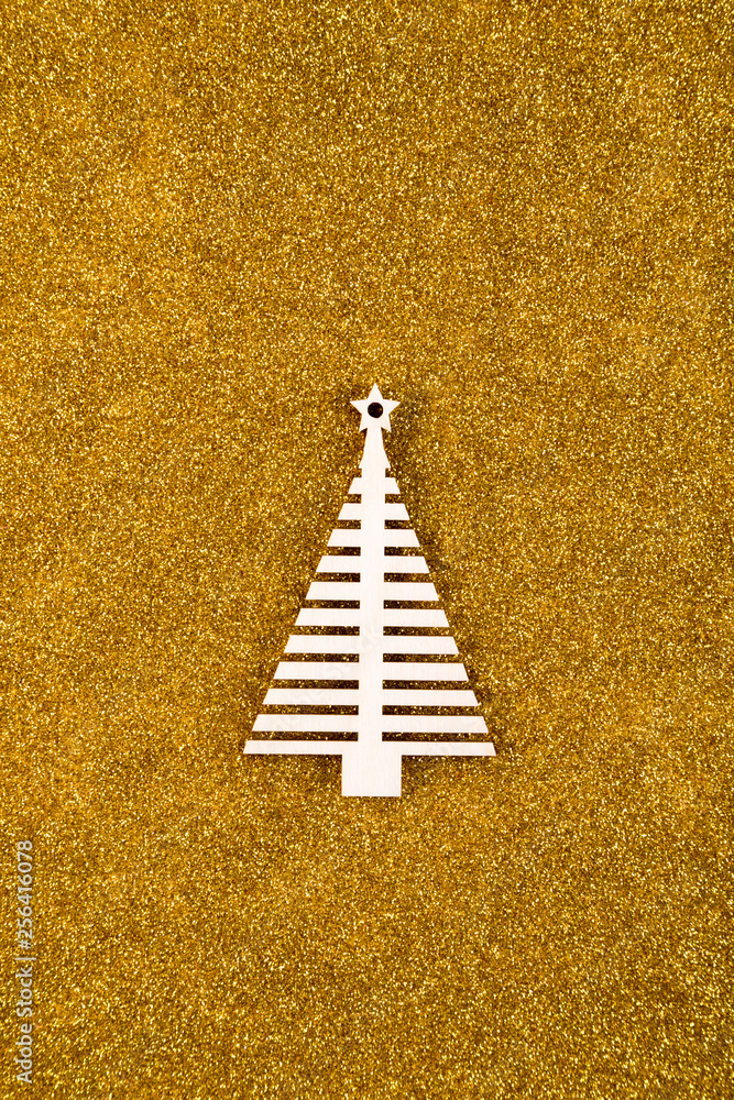 Obraz premium Wooden Christmas tree shape on golden glitter background 