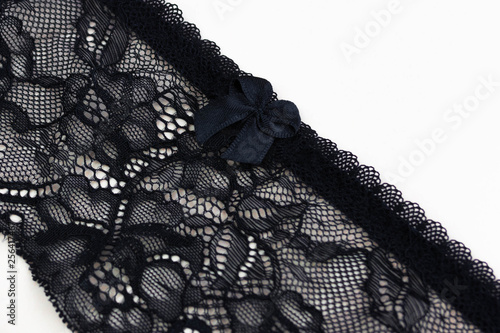 Lace black belt for stockings or suspenders on a peach background