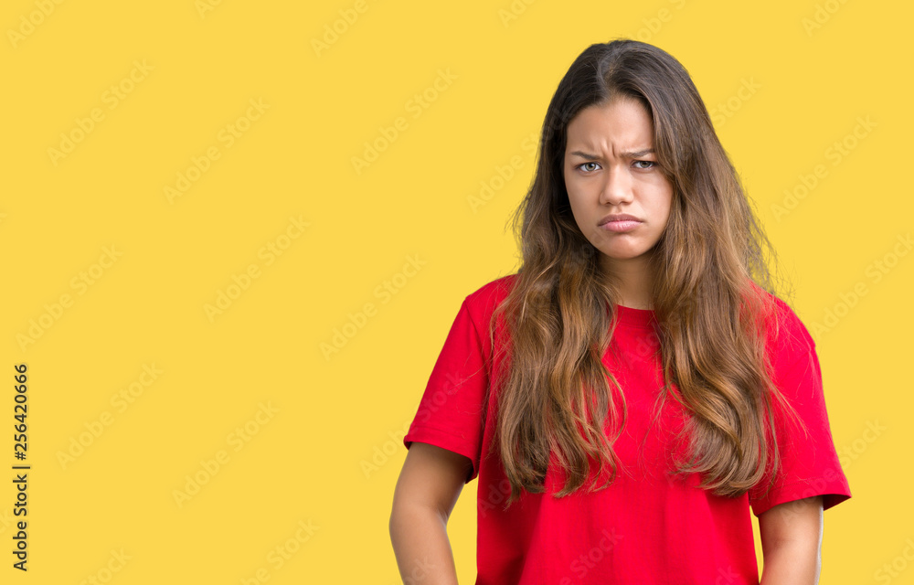 Young beautiful brunette woman wearing red t-shirt over isolated background skeptic and nervous, frowning upset because of problem. Negative person. Young beautiful brunette woman wearing red t-shirt over isolated background skeptic and nervous, frowning upset because of problem. Negative person.