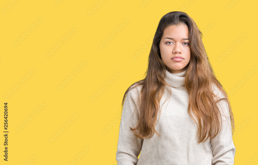 Obraz premium Young beautiful brunette woman wearing turtleneck sweater over isolated background Relaxed with serious expression on face. Simple and natural looking at the camera.