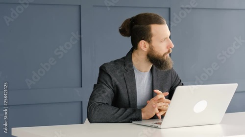 From indecision to brilliant idea. Pensive hesitant business man waiting for inspiration. Typing on laptop. Communication.