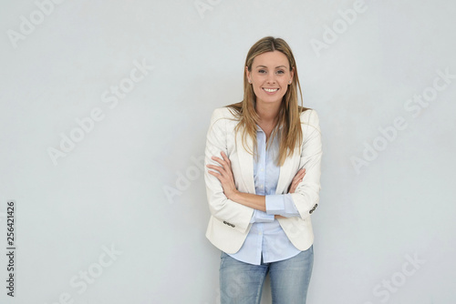 Dynamic businesswoman looking at camera on grey background