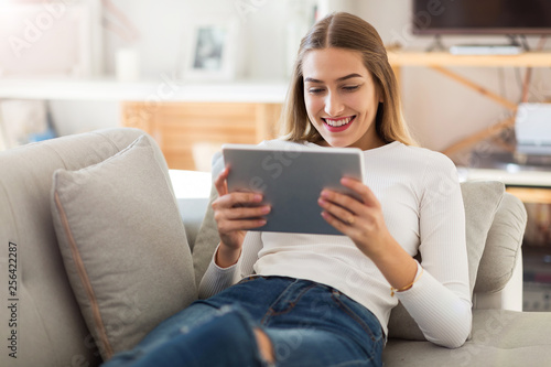 Young woman using digital tablet at home