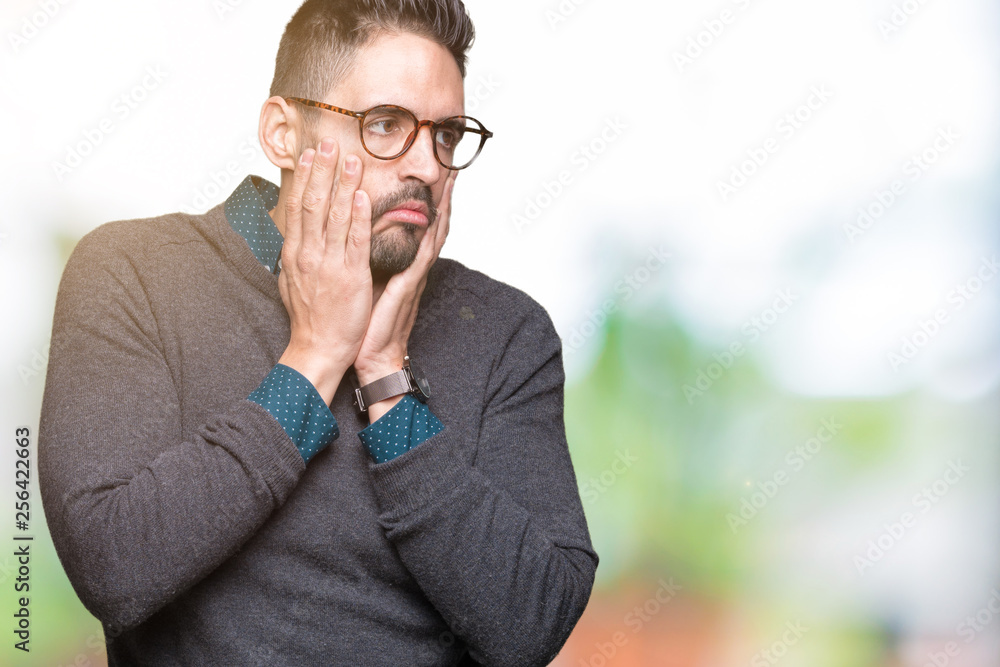 Young handsome man wearing glasses over isolated background Tired hands covering face, depression and sadness, upset and irritated for problem Young handsome man wearing glasses over isolated background Tired hands covering face, depression and sadness, upset and irritated for problem