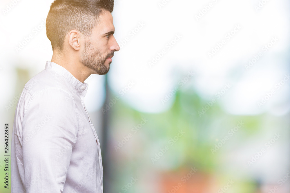 Fototapeta premium Young business man over isolated background looking to side, relax profile pose with natural face with confident smile.