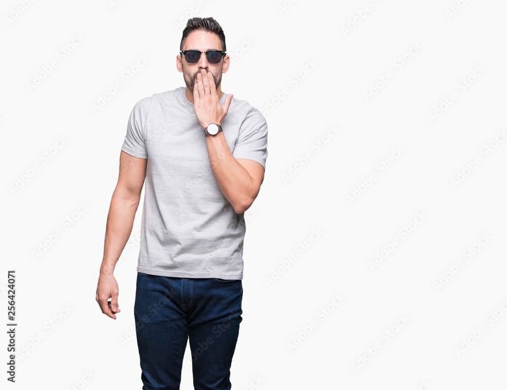 Fototapeta premium Young handsome man wearing sunglasses over isolated background cover mouth with hand shocked with shame for mistake, expression of fear, scared in silence, secret concept