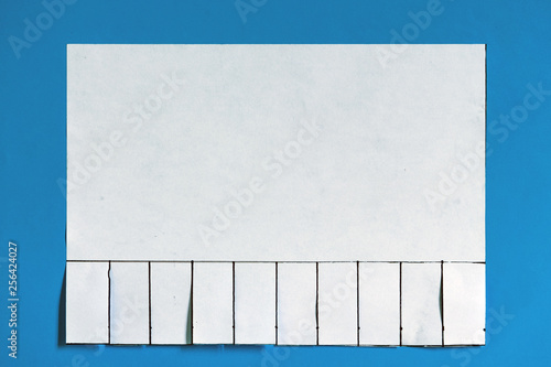 Different stages of private handmade announcement with tear off tabs on the wall. Blank white paper announcement with tear off tabs.