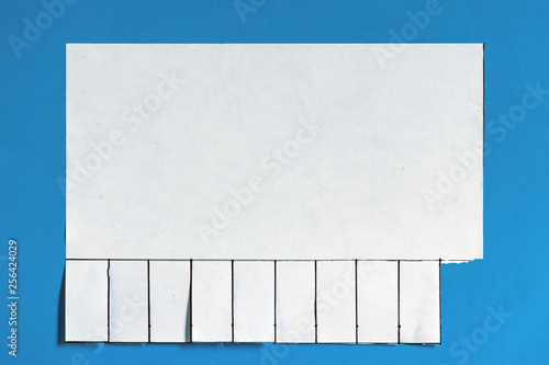 Different stages of private handmade announcement with tear off tabs on the wall. Blank white paper announcement with tear off tabs.