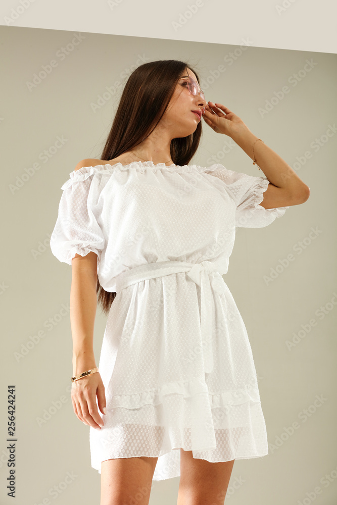 Fototapeta premium Slim young woman in white summer dress