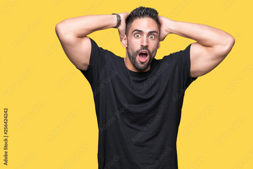 Young handsome man over isolated background Crazy and scared with hands on head, afraid and surprised of shock with open mouth Young handsome man over isolated background Crazy and scared with hands on head, afraid and surprised of shock with open mouth