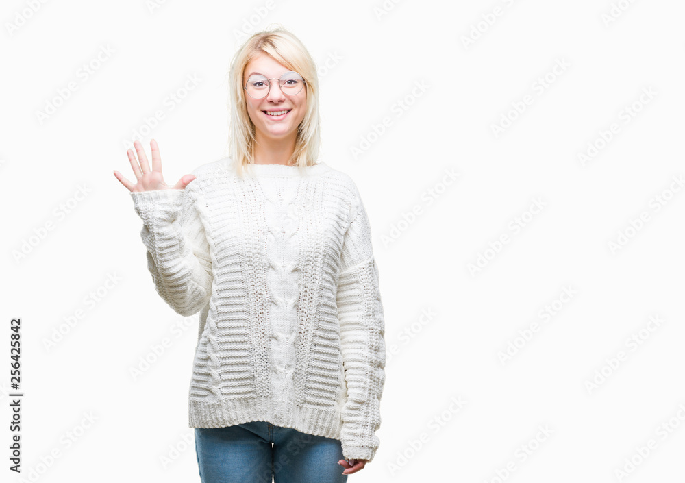 Young beautiful blonde woman wearing winter sweater and glasses over isolated background showing and pointing up with fingers number five while smiling confident and happy. Young beautiful blonde woman wearing winter sweater and glasses over isolated background showing and pointing up with fingers number five while smiling confident and happy.