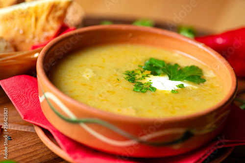 Cream soup in ceramic bowl on wooden table