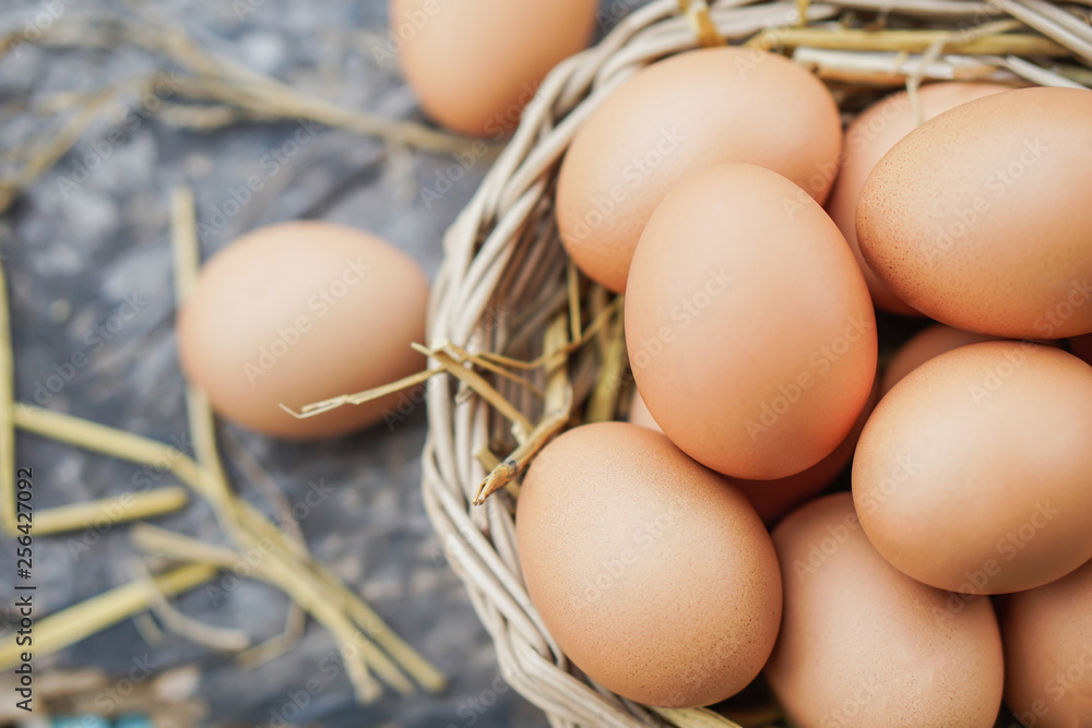 chicken eggs in basket on wooden table closeup chicken eggs in basket on wooden table closeup