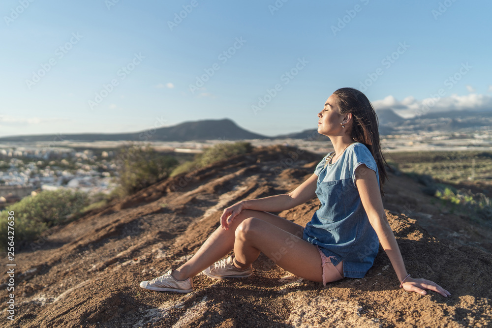 Pretty tourist brunette girl relaxing near mountains. Pretty tourist brunette girl relaxing near mountains.
