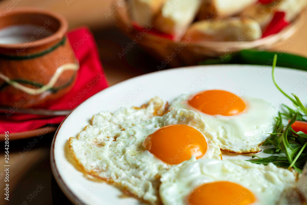 Fried eggs with cheese and tomatoes, breakfast Fried eggs with cheese and tomatoes, breakfast