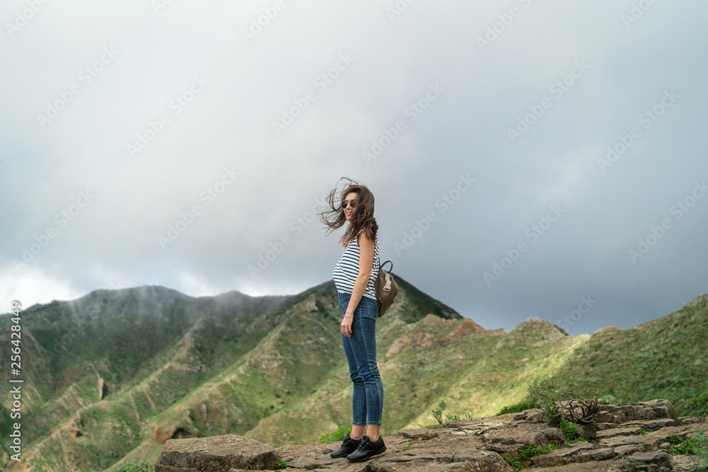 Pretty tourist brunette girl relaxing near mountains. Pretty tourist brunette girl relaxing near mountains.