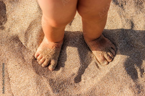 Fototapeta Naklejka Na Ścianę i Meble -  Baby feet walking on sand beach in the summer.