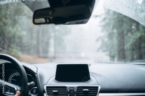 Man driving car with view from inside.