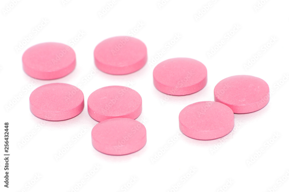 Tablets of pink color on a white background, there is a place for text. Tablets of pink color on a white background, there is a place for text.