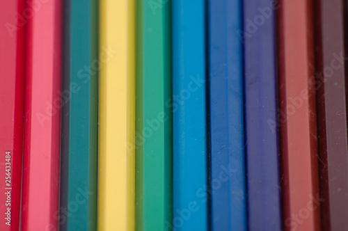Many colored pencils, macro, view from the top, with space for text.