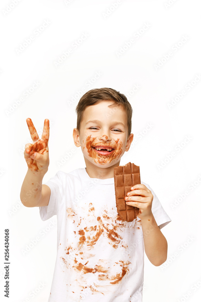 little boy with face and hands in chocolate little boy with face and hands in chocolate